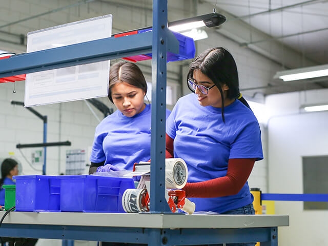 Woman employees working on product together