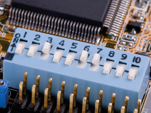 Macro close up of DIP switch mounted to a PC board