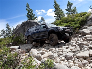 Car driving off road on uneven rocks