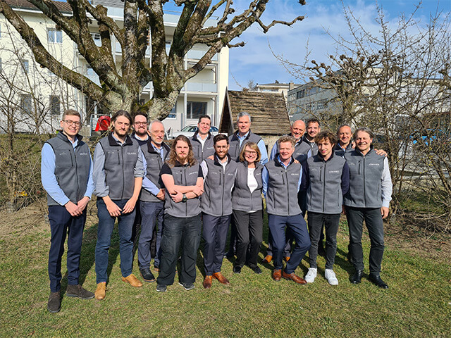 Group of employees huddled together outdoors in Switzerland