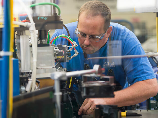Man working with machine with safety glasses on