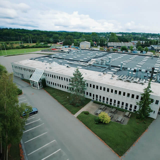 CTS facility with parking lot and seating area on green grass located in Kvistgaard, Denmark