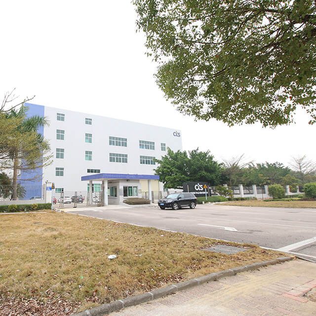 CTS facility with tree shadowing drive way entrance with car parked in front, located in Zhongshan, China