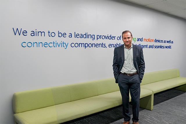 CEO Kieran O'Sullivan smiling with hand in pocket, standing in manufacturing area