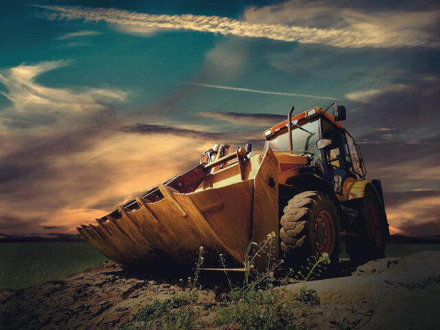 Excavator/bulldozer next to gravel pit