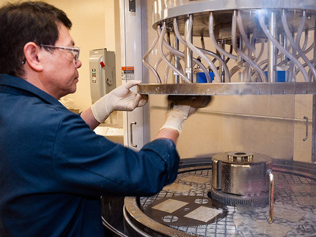Man cleaning manufacturing equipment