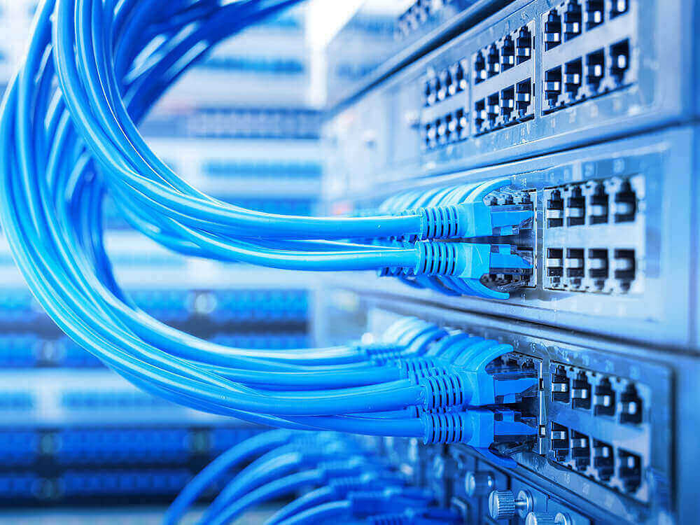Blue ethernet cable going into electronic equipment