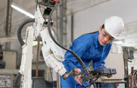 Engineer inspecting robotic arm