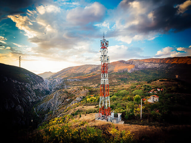 Red-orange communication Antenna on hillside