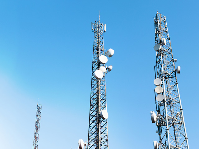 communication towers against a blue sky