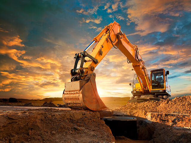 Excavator digging in dirt in construction site