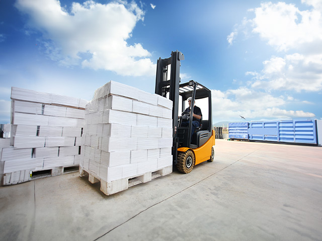 Man using forklift to pickup blocks