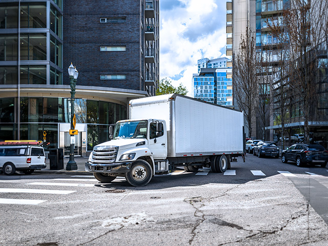 Large truck turning down city street